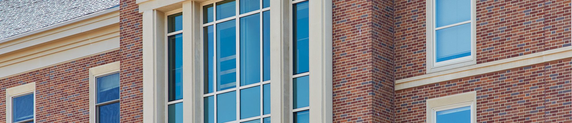 Exterior of Pioneer Hall brick building with blue windows