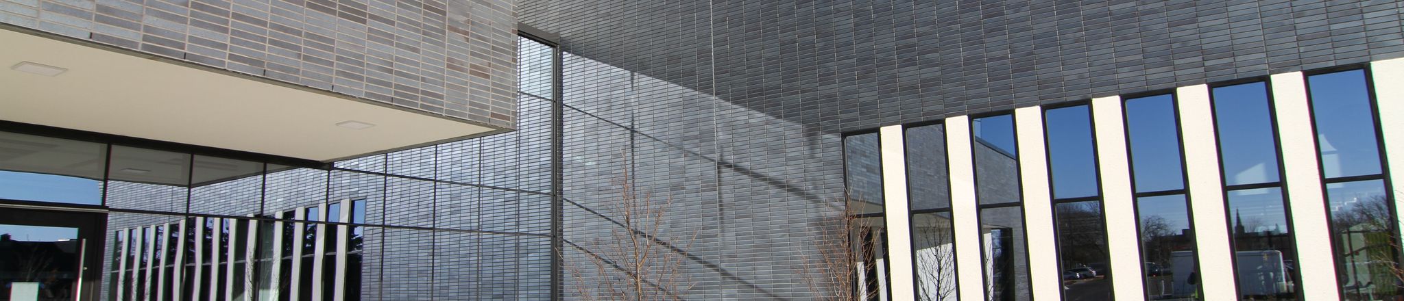 Image of the front of Austin Community Recreation Center with a blue sky in the background