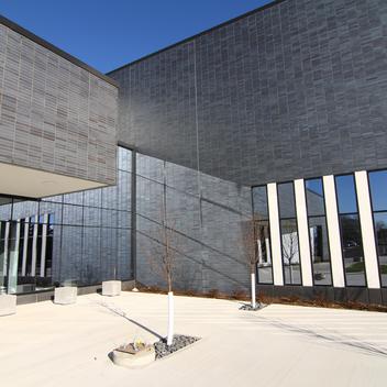 Image of the front of Austin Community Recreation Center with a blue sky in the background