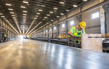 worker in production facility with rebar