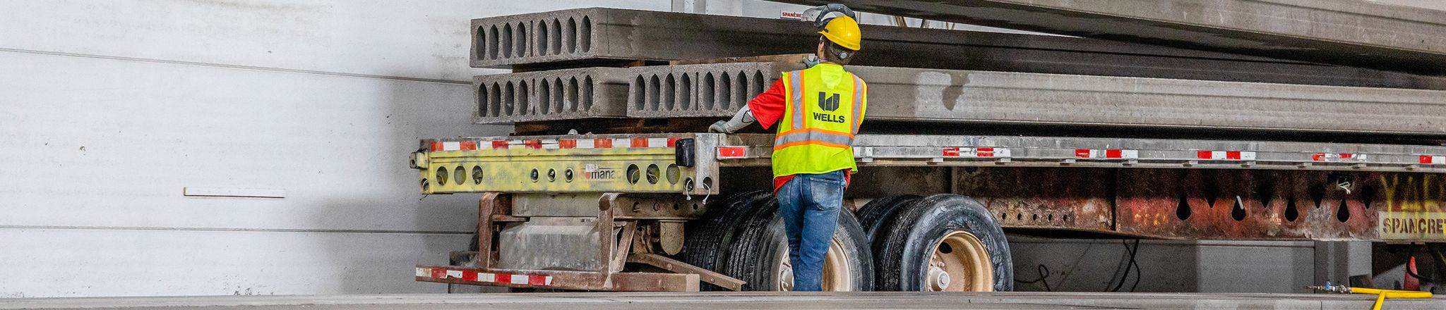hollowcore being stacked on a flatbed truck in manufacturing facility