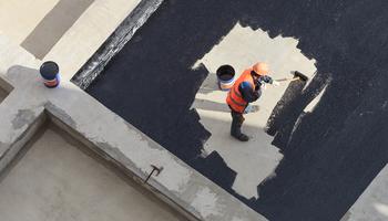 photo of worker waterproofing with roll-on waterproofing agent