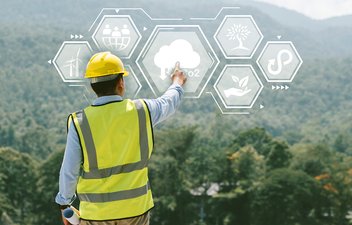 worker in hard hat and vest with sustainability buttons