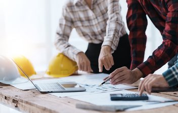 two engineers looking at construction drawings