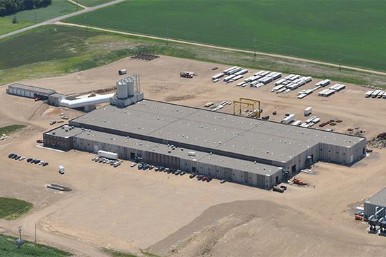 Aerial shot of green landscape with Wells Corporate office building and roads surrounding it