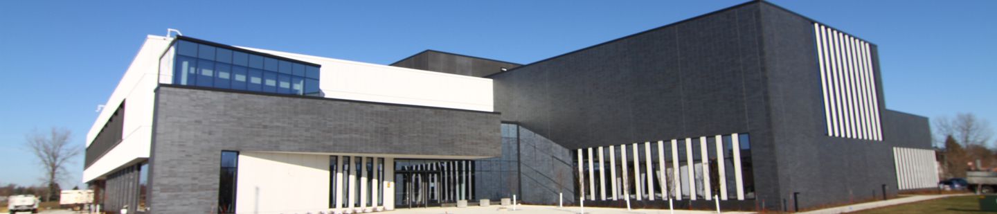 Image of the front of Austin Community Recreation Center with a blue sky in the background
