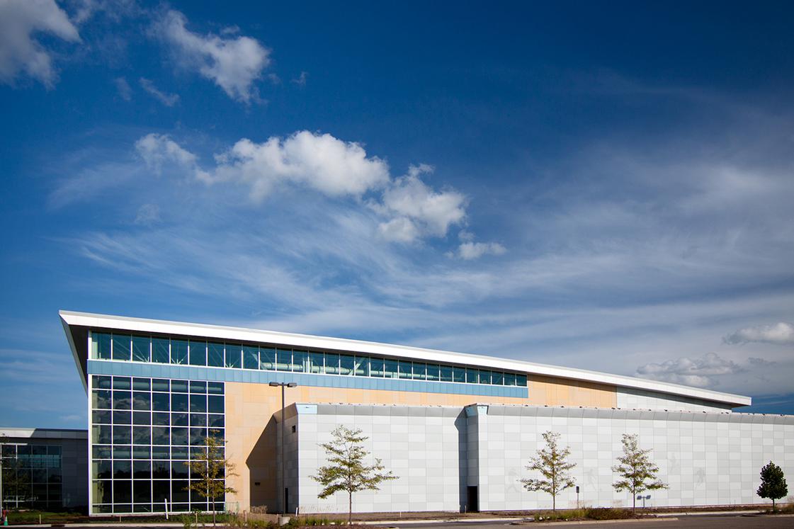 Wide picture of Bielenberg Sports against a bright blue sky with clouds