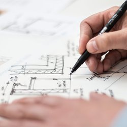 image of person working on a blueprint