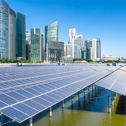 Image of solar panels with a city in the background