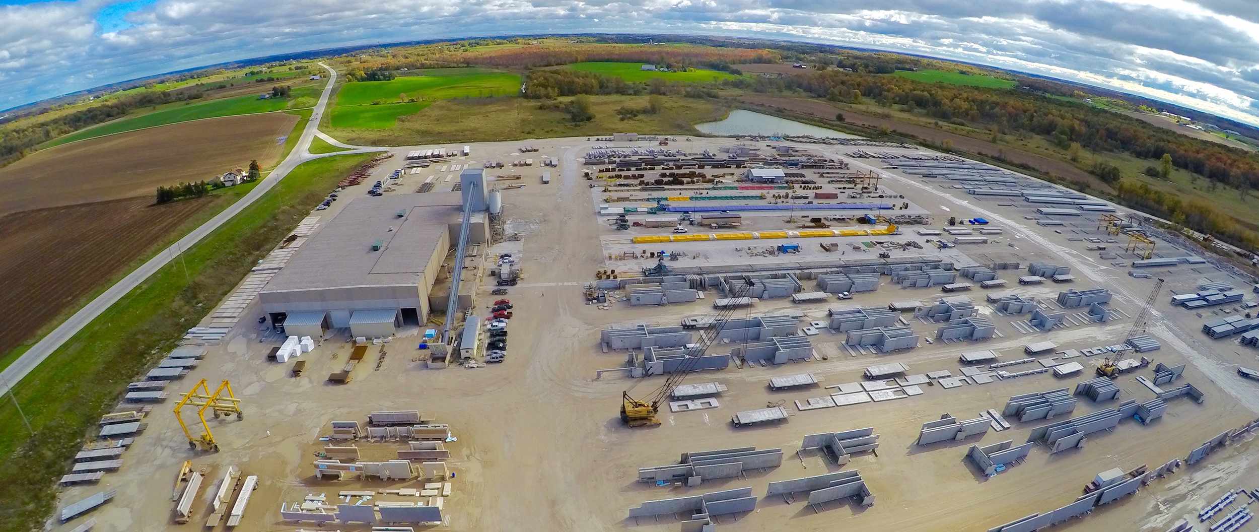 Aerial Exterior shot of wells facility backlot with products and blue sky