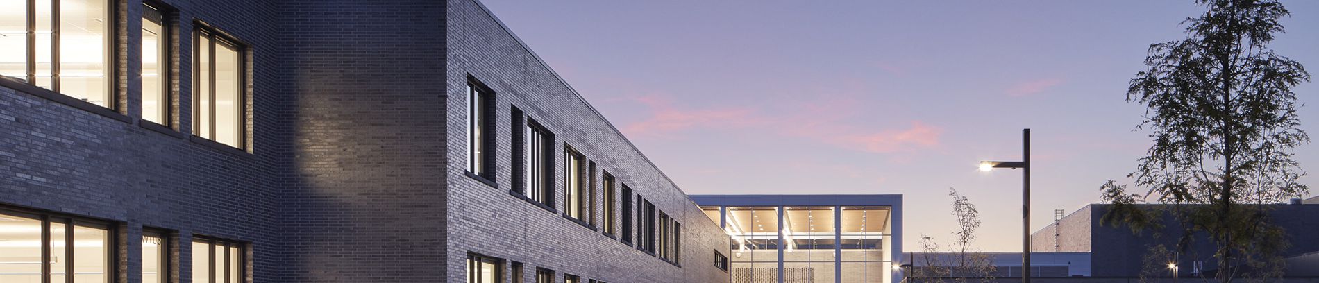 Sunset view of Sartell High School with emphasis on brick exterior