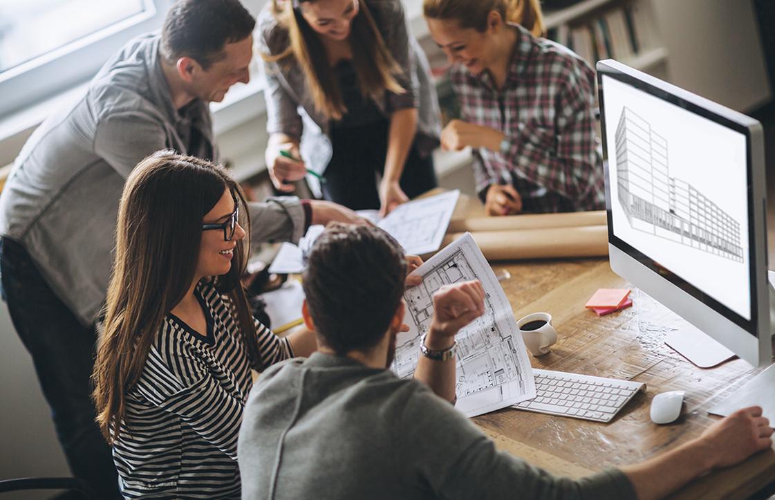 Image of people sitting around a desk.