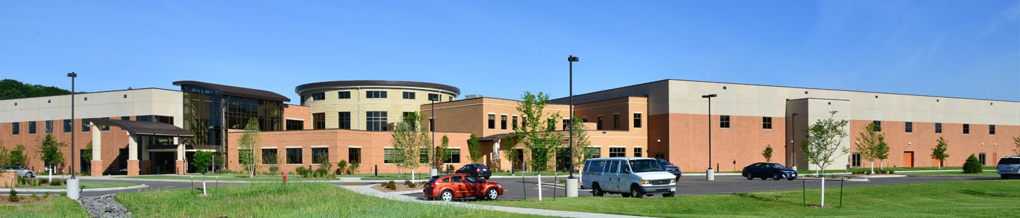 Wide shot of Lunda Community Center on a bright day