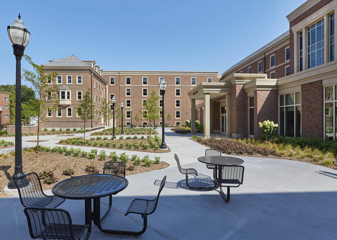 Courtyard view of Pioneer Hall, with tables and benches
