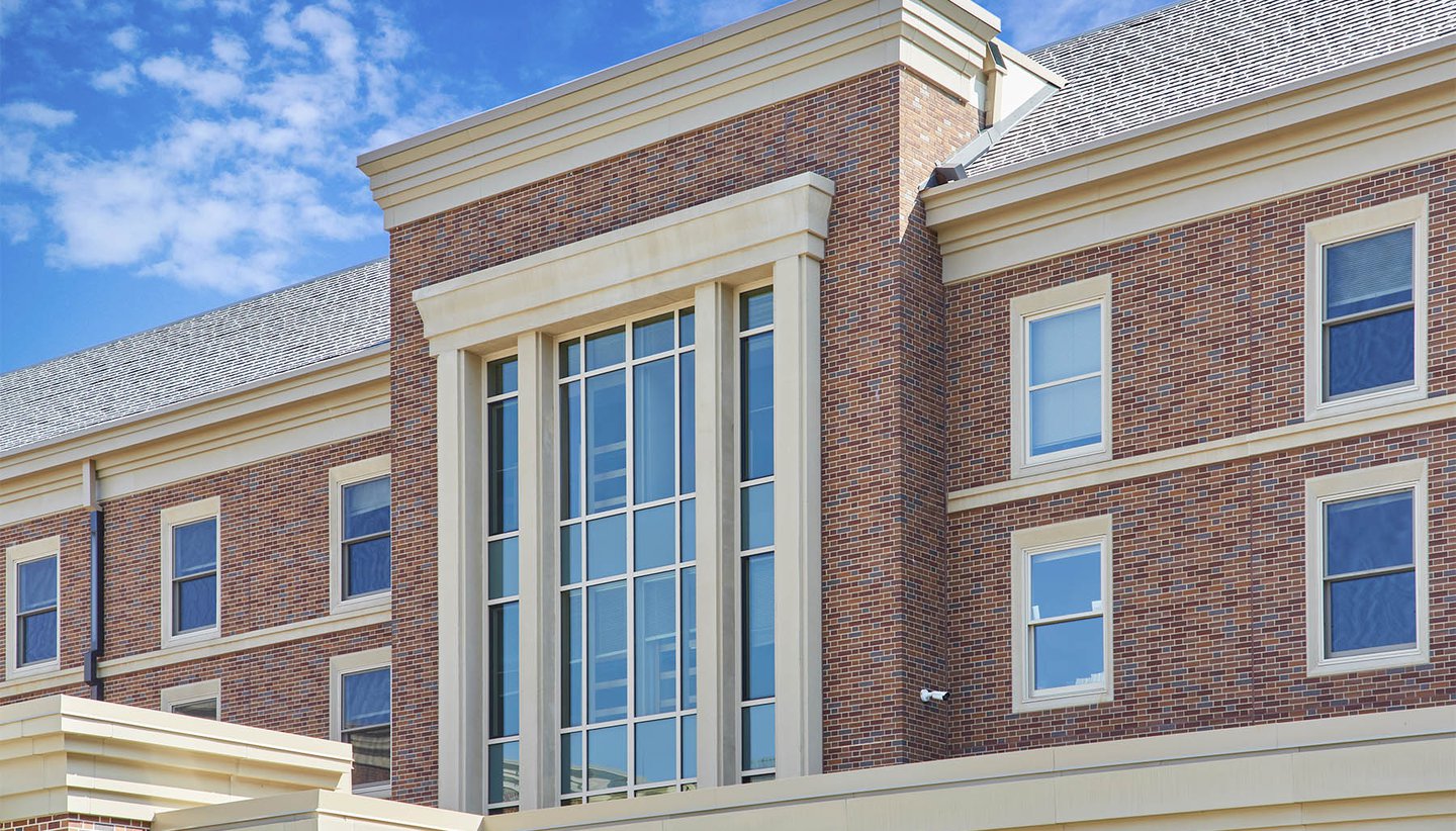Exterior of Pioneer Hall brick building with blue windows