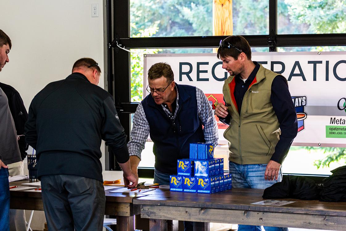 Men running a booth for event sign up and check in
