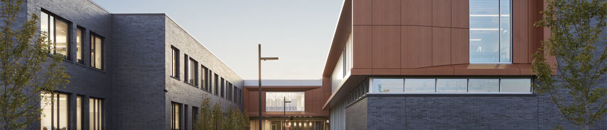 Sunset view of Sartell High School with emphasis on brick exterior