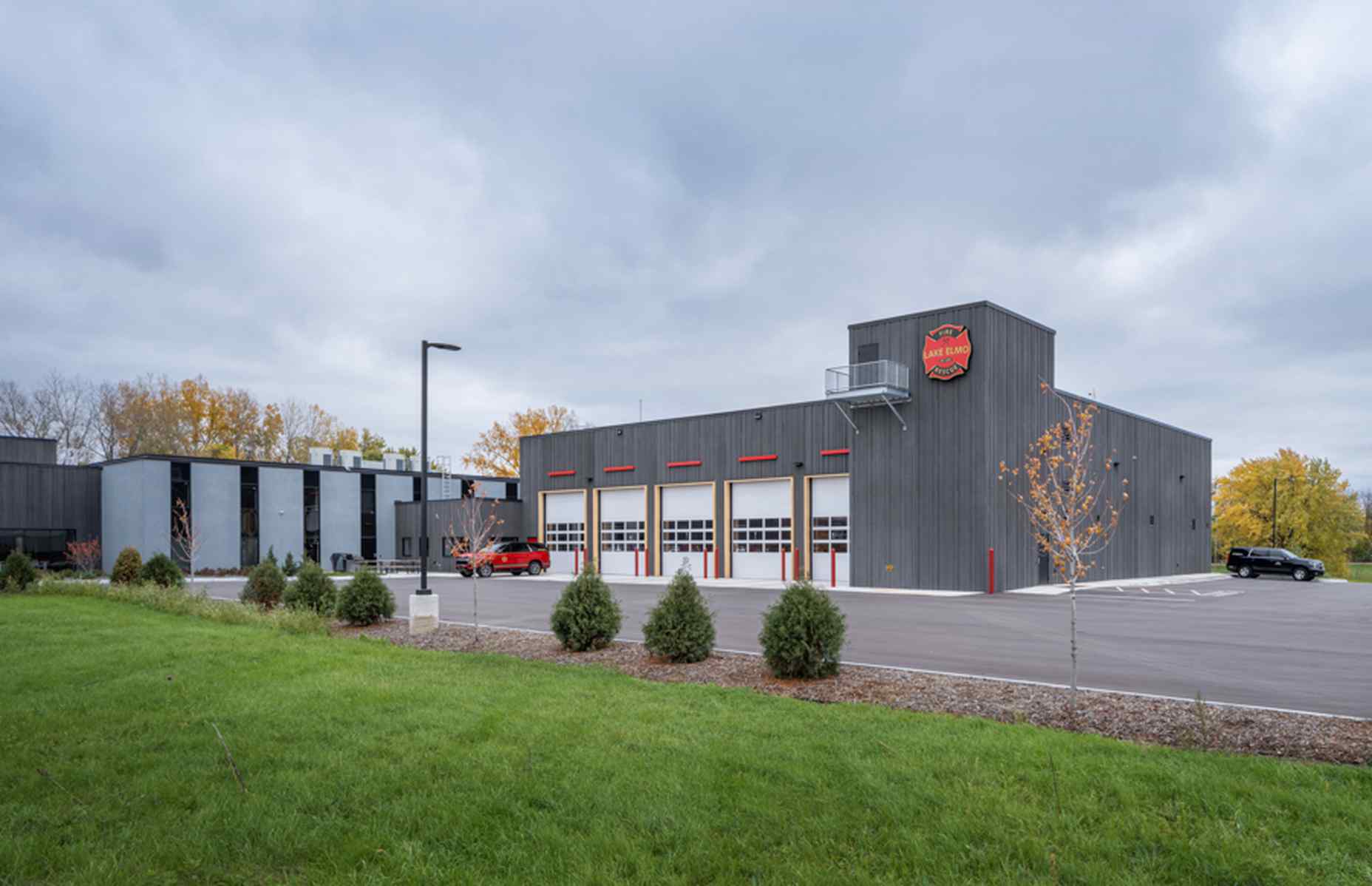 backside of lake elmo city center with closed fire station garage doors