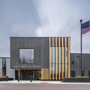 entrance of lake elmo city center with flag and sky
