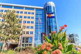 view of 100 saint paul with colorado state flag and flowers