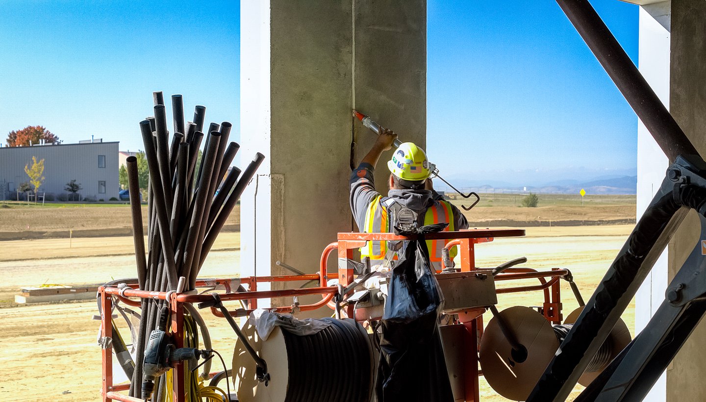 worker applying sealants to a precast joint