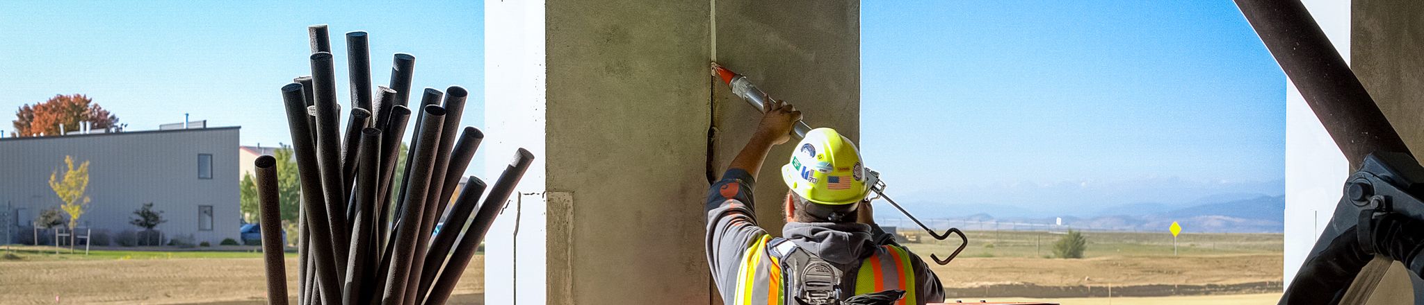 worker applying sealants to a precast joint