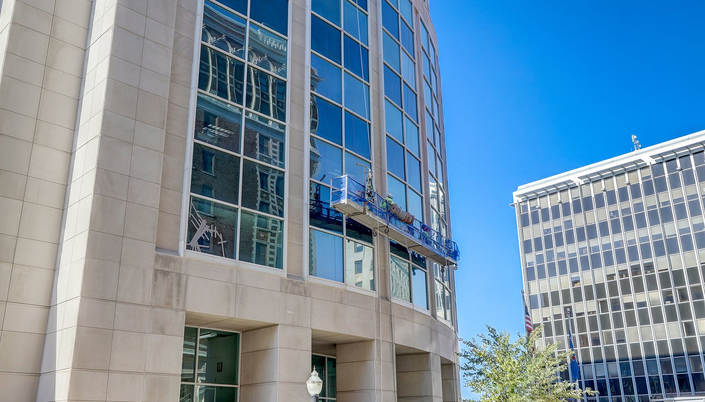 wells workers performing restorative services on building exterior