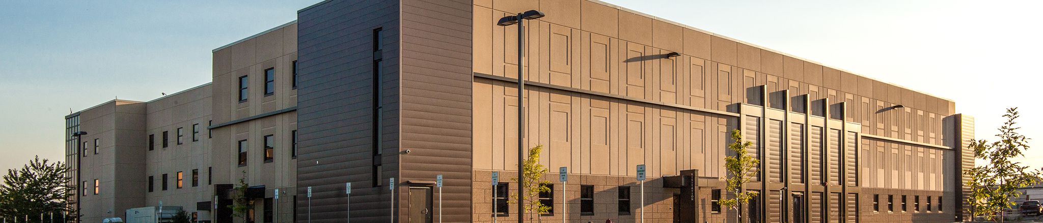 exterior full view of williams county jail with parking lot and sky