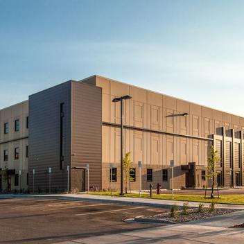 exterior full view of williams county jail with parking lot and sky
