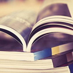 Open handbook on top of other handbooks.