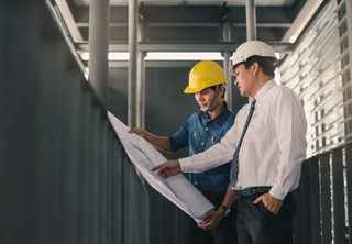 Two engineers talking about a drawing