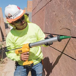 A contractor sealing a wall.