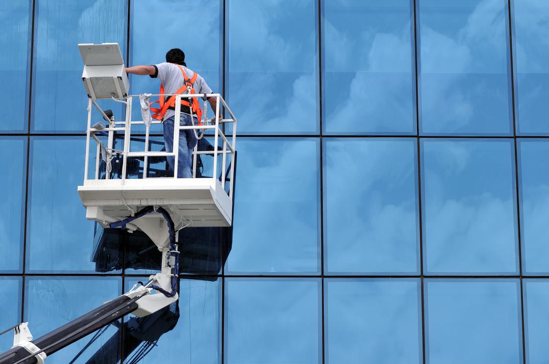 Person on a lift outside of a building
