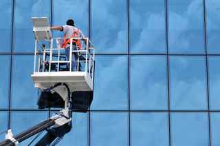 Person on a lift outside of a building